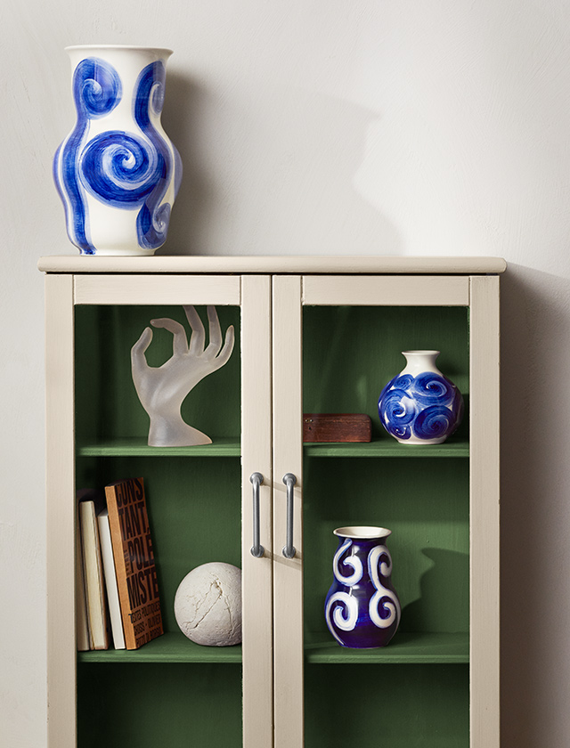 Die Tulle Vasenserie von Kähler Design ist eine exquisite Darstellung von Kunst und Handwerk, handbemalt in nuancierten Blau-Weiss Tönen. Jedes Stück dieser Serie zeichnet sich durch kreisförmige und verschnörkelte Muster aus, die eine zeitlose Eleganz vermitteln. Als Hommage an die renommierte Designerin Tulle Emborg, vereint die Nulle-Serie traditionelle Handwerkskunst mit moderner Sensibilität. Die Vasen sind in drei sorgfältig ausgewählten Größen von 10 cm, 12,5 cm und 22 cm erhältlich und bieten die Möglichkeit, sowohl subtile Akzente als auch auffällige Statements in jedem Raum zu setzen.
